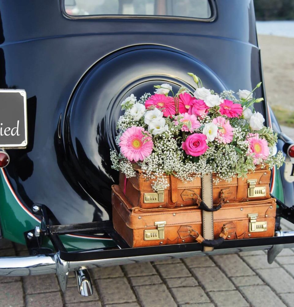 vintage wedding car with antique suitcases