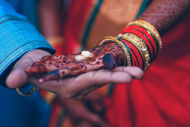 engagement rings on hand couple