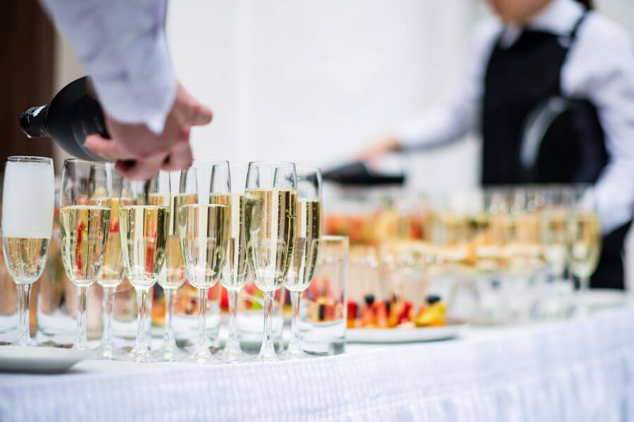 Essentials To Book In Advance When Planning A Wedding 3 wedding catering team pouring drinks